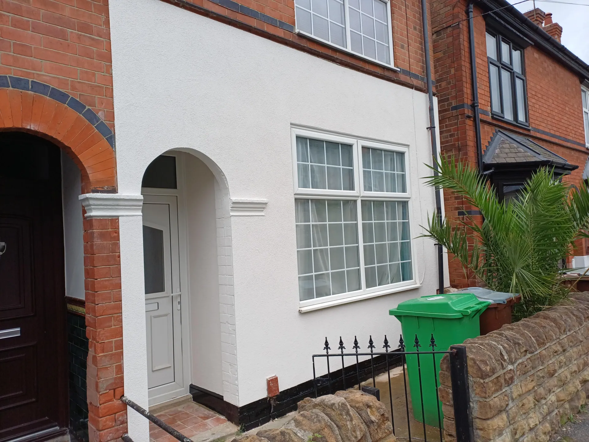 House front elevation finished in clean white silicone render